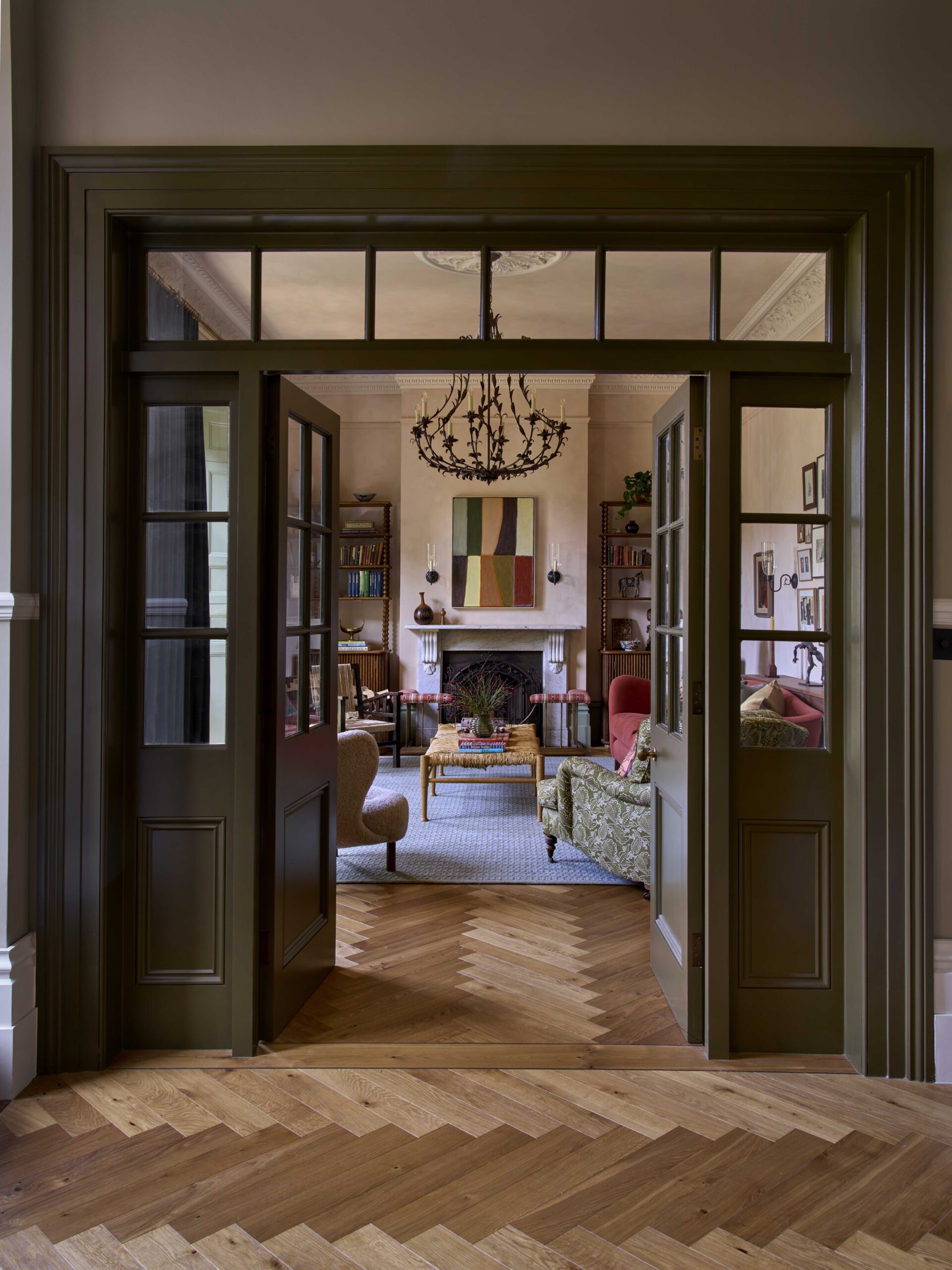 View through grand double doors connecting the hallway to the colorful living space